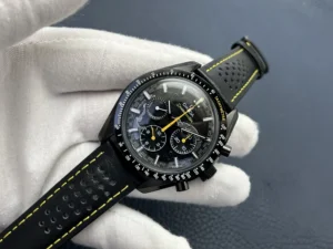 Held in a glove, yellow chronograph hand over the textured dial