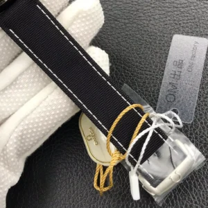 Strap buckle in protective film with a cream Omega tag
