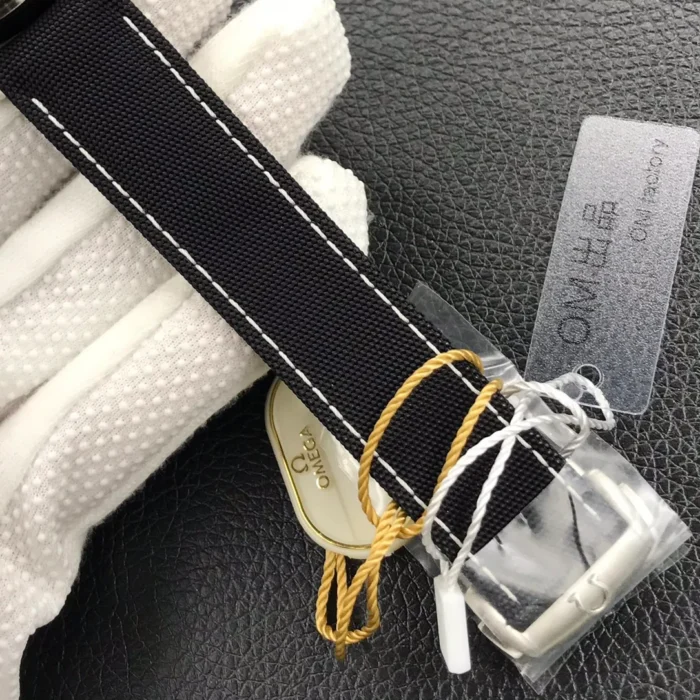 Strap buckle in protective film with a cream Omega tag
