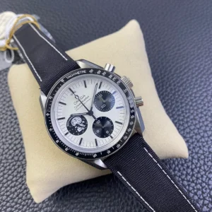 Angled on a cushion, white dial with black counters and the navy strap