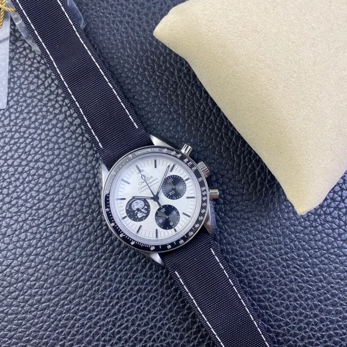 Whole watch at an angle on the navy fabric strap